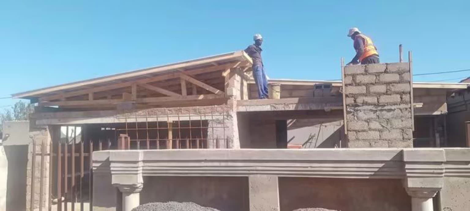 Builders working on a roof stage